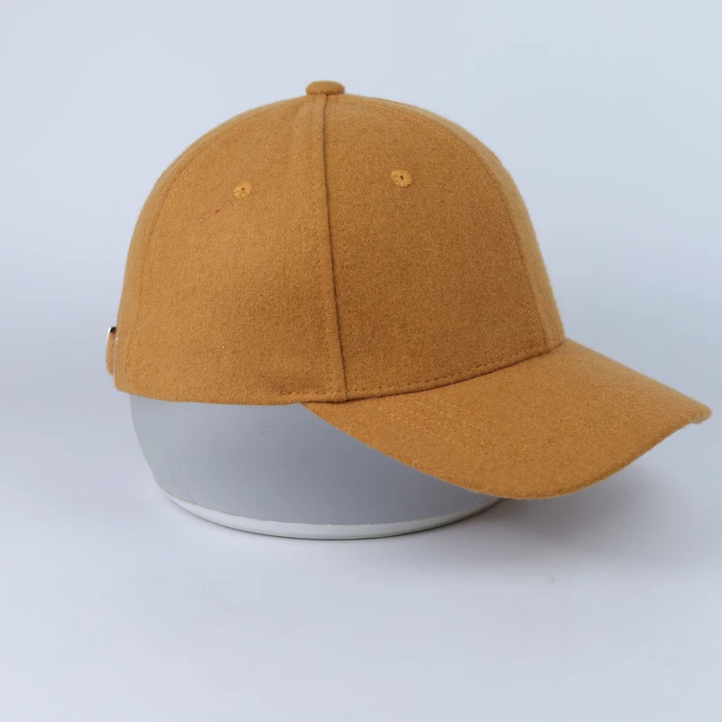 Tan blank cap with suede-like surface and curved visor viewed from the front side