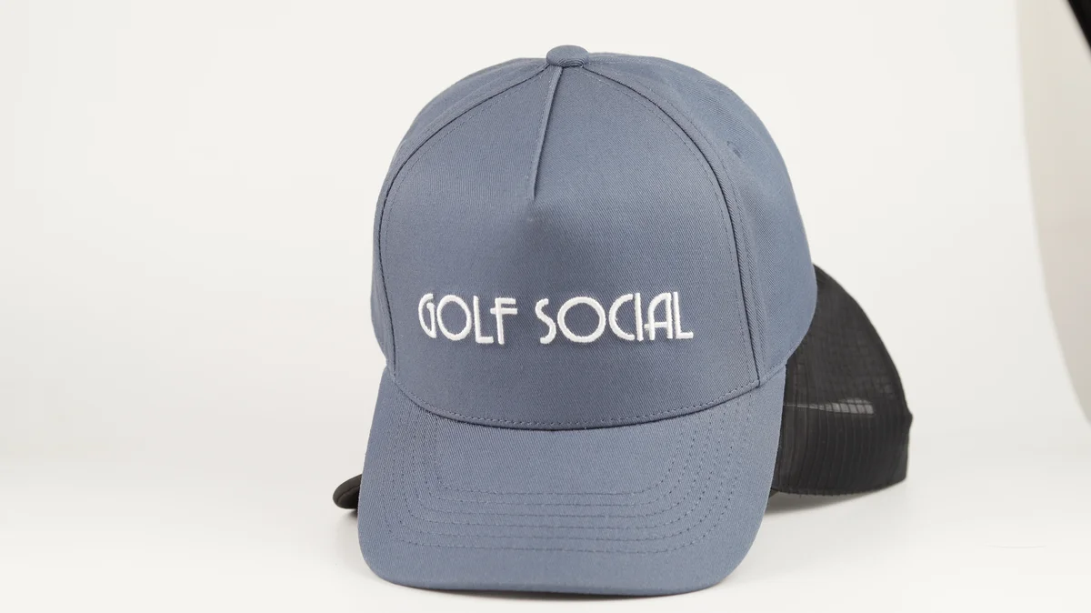 Grey cap with white front lettering, with a separate dark cap behind it