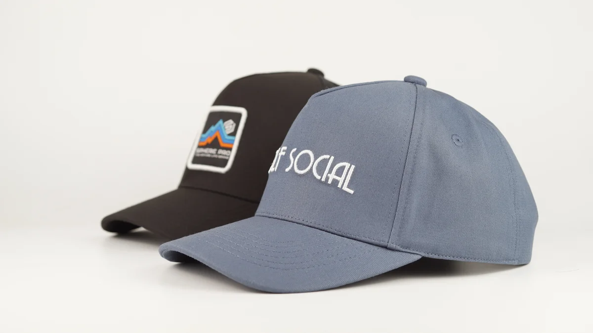 Grey embroidered cap and separate dark patch cap shown side by side